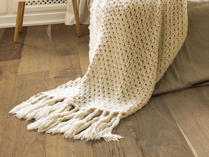 Blanket-Hanging-Off-Chair-Sliding -Onto-Hardwood-Floor